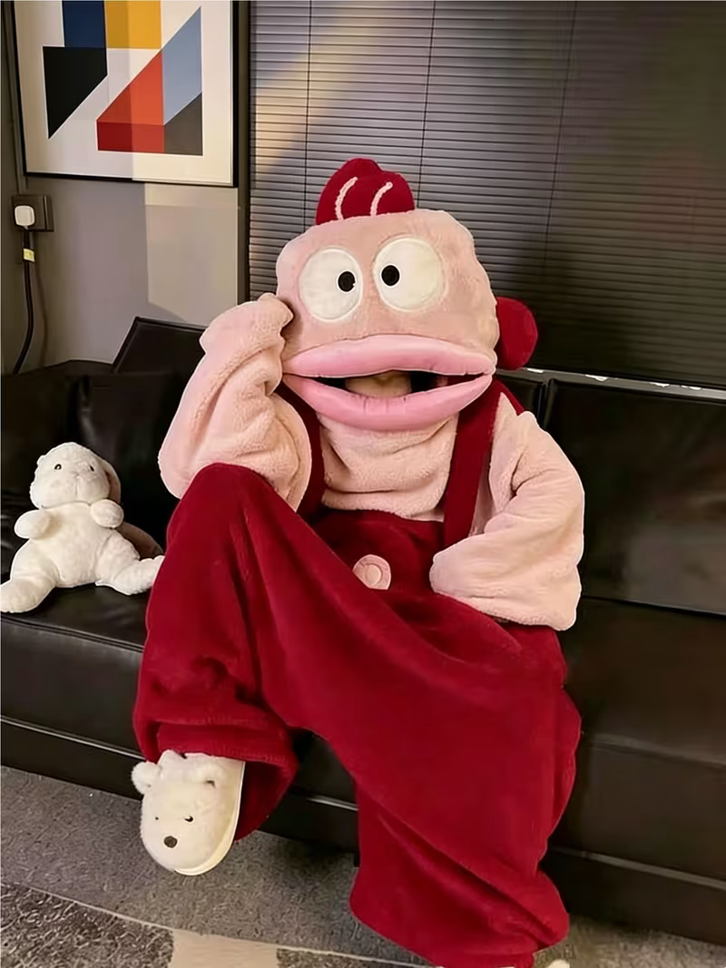 Onzis pink fish onesie worn with the hood up